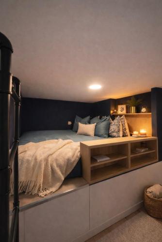 a bedroom with a bed with a nightstand next to it at La Petite Escale Manosquine in Manosque