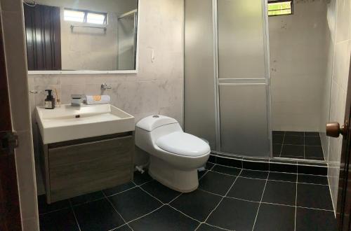 a bathroom with a toilet and a sink and a shower at Finca Hotel San Sebastian in La Paloma