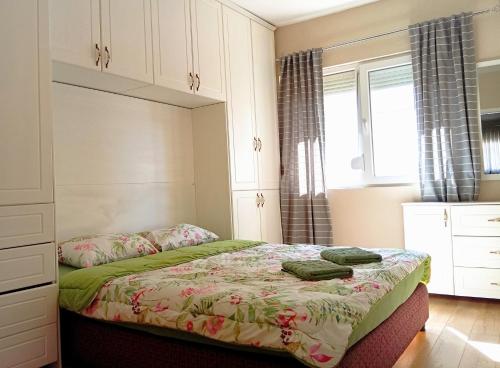 a bedroom with a bed and a window at Harmony Apartment in Strumica