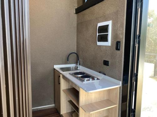 a small kitchen with a sink and a refrigerator at Apalta Vista Wine Lodge in Estación Santa Cruz