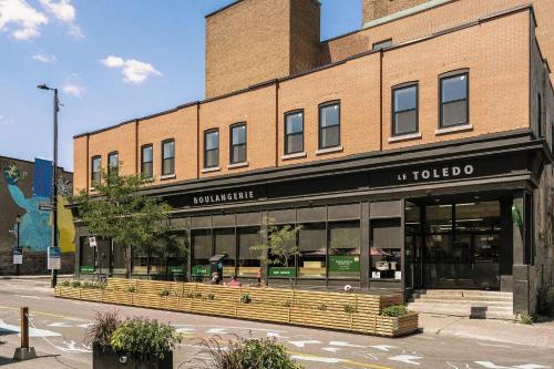 a store front of a brick building on a street at The Cove Hotel in Montréal