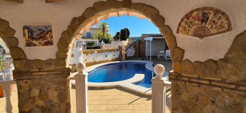 an archway in a building with a swimming pool at Enjoy complete seclusion at Casa Delfin, featuring your own stunning private pool and sunset views in Gran Alacant