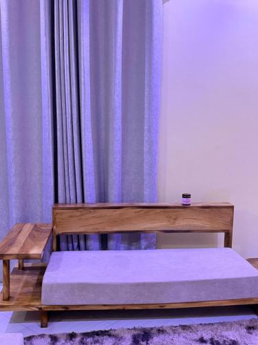 a wooden bench sitting in front of a curtain at Ways Rest in Msaranga