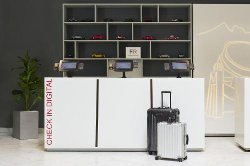 a store with a white counter with a suitcase at Fiesta Inn Monterrey la Fe in Monterrey