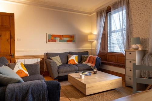 a living room with two couches and a coffee table at Hallbank Hideout in Amble