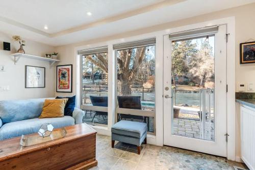 a living room with a couch and a table at Riverfront Cottage - Steam Room & Pet Friendly in Bend