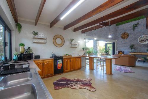 a large kitchen with a table in the middle of it at Edjami River View in Marloth Park