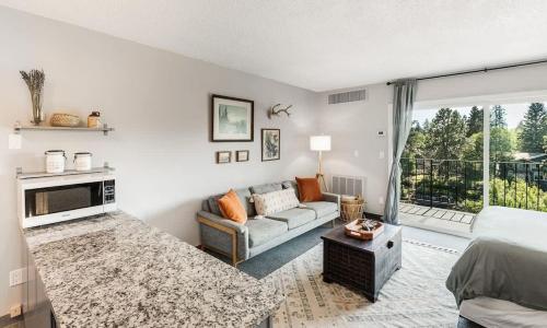 a living room with a bed and a couch at Riverview Pet Friendly Condo in Downtown Bend in Bend