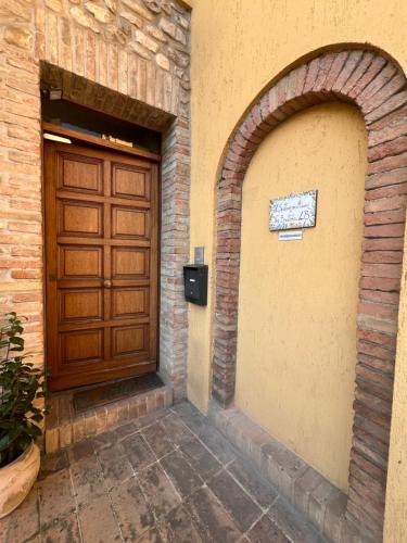 an entrance to a building with a wooden door at Il sentiero per Assisi in Bastia Umbra