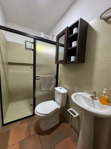 a bathroom with a toilet and a sink at Finca Sol y Luna in San Gil