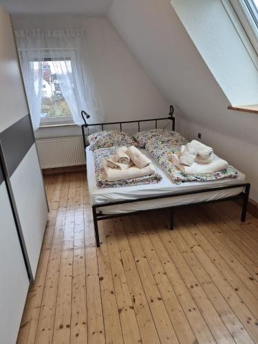 a bedroom with a bed with towels on it at Solarhaus Guxhagen in Guxhagen