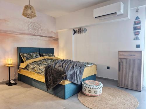 a bedroom with a bed and a table in it at Boho Studio Enjoy in Neoi Epivates