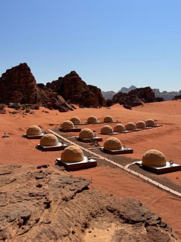 a group of domes sitting in the desert at Mangle luxury rum camp in Disah