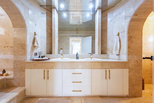 a bathroom with two sinks and a mirror at Cozy Villa With Pool In Marbella Nueva Andalucia in Marbella