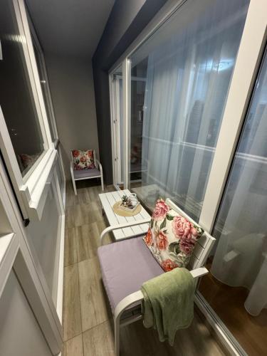 a small room with a chair and a window at Mira in Čajetina