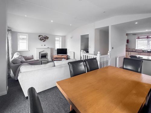 a living room with a couch and a table at Royal Retreat in Wisbech