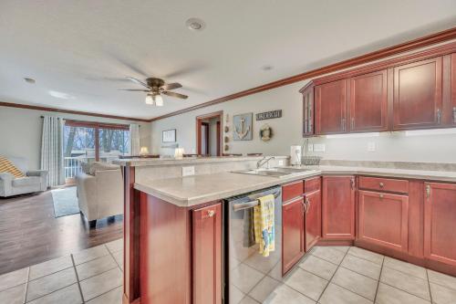 a kitchen with red cabinets and a living room at 84 Rohr 7B in Arnolds Park
