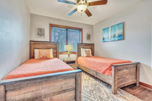 a bedroom with two beds and a ceiling fan at 84 Rohr 7B in Arnolds Park