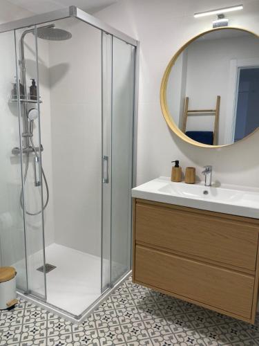 a bathroom with a shower and a sink and a mirror at A Ribeira - BoaOnda in Cee