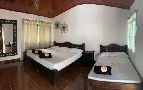a bedroom with two beds and a mirror at Finca Hotel San Sebastian in La Paloma