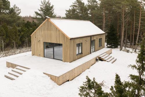 a cabin in the woods in the snow at Charming Seaside Country Cottage in Myza Lakhetaguze