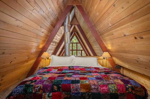 a bedroom with a large bed in a wooden ceiling at Snowball House in Government Camp