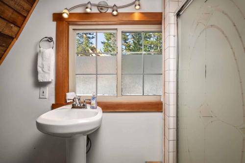a bathroom with a sink and a window at Snowball House in Government Camp