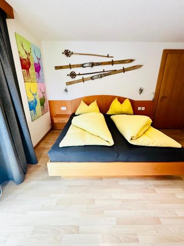 a bedroom with a bed with skis on the wall at Apart Jil-Marie Studio 7 in Samnaun