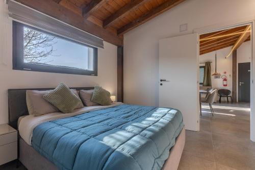 a bedroom with a large bed with a window at Suite Home Ferrara in Ferrara