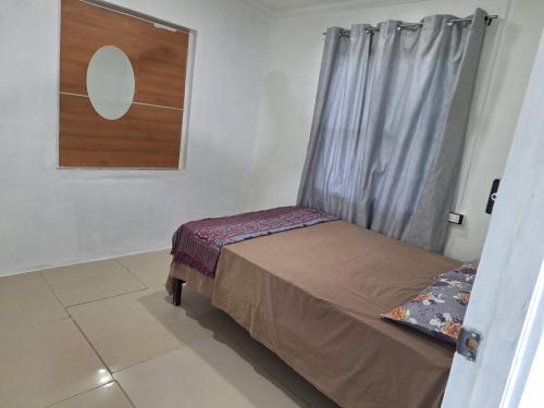 un petit lit dans une chambre avec une fenêtre dans l'établissement Singhs, à Nadi