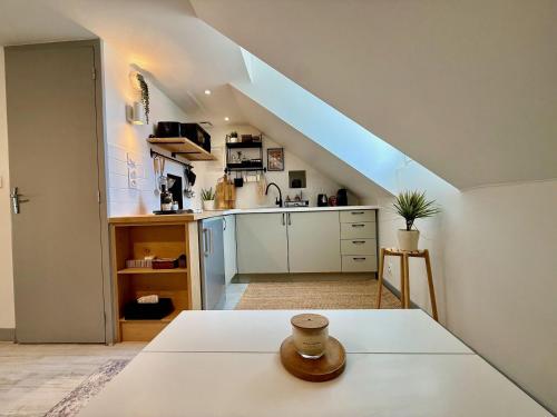 a room with a kitchen with a staircase at Studio du Vieux Marché in Romorantin