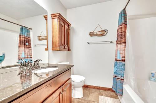 a bathroom with a sink and a toilet at Bridges Bay Vacation Cabin 115 in Arnolds Park