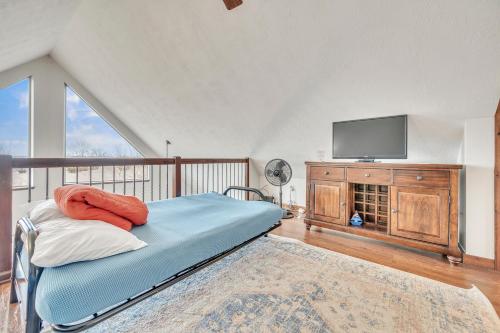 a bedroom with a bed and a tv on a balcony at Bridges Bay Vacation Cabin 115 in Arnolds Park