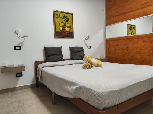 a bedroom with a bed with a stuffed animal on it at Heidi's home in Villabate