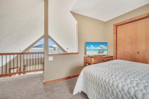 a bedroom with a bed and a balcony at Bridges Bay Vacation Cabin 69 in Arnolds Park