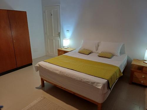 a bedroom with a large bed with two pillows at Djerba Beach Haven in Aghīr