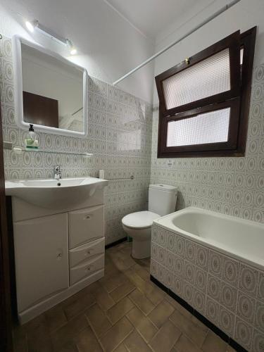 a bathroom with a sink and a tub and a toilet at Casa Calma in L'Escala