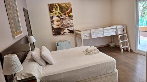 a small bedroom with two beds and a ladder at Chalet La Serreta in Alicante