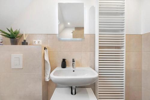 a bathroom with a white sink and a mirror at P & A Ferienwohnung in Soltau