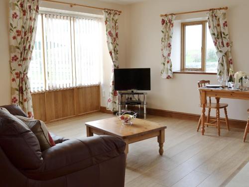 a living room with a couch and a table at The Smithy - Op6 in Carmarthen
