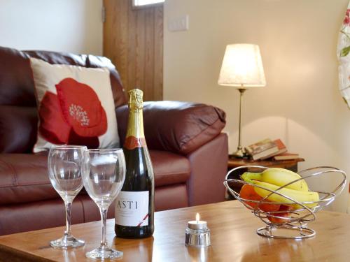a bottle of champagne and two glasses on a table at The Smithy - Op6 in Carmarthen