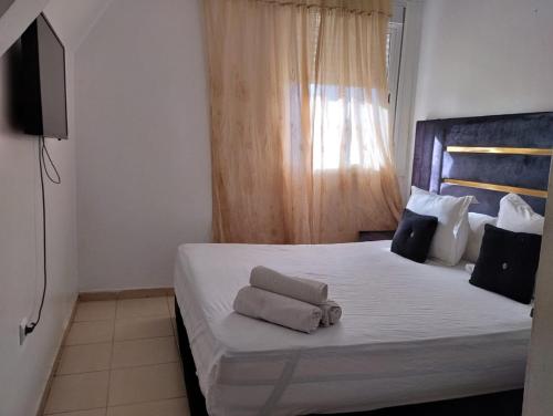 a bedroom with a bed with two towels on it at Dar Yasmine 2 in Ifrane