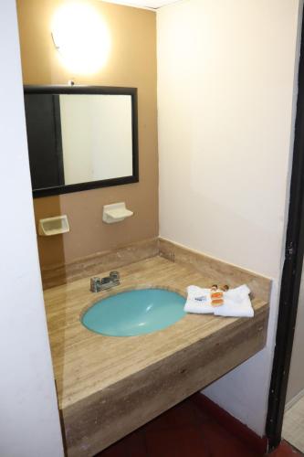 a bathroom with a tub with a sink at Hacienda Blue Bay in Mazatlán