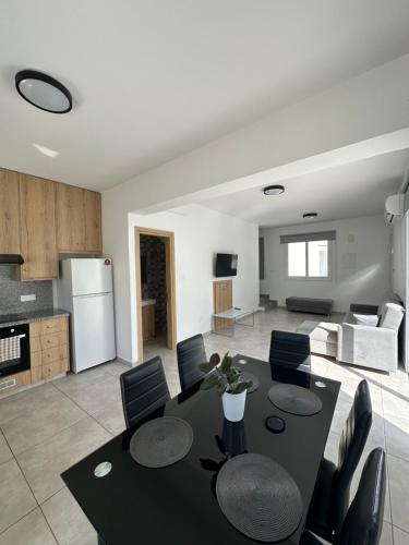 a kitchen and living room with a table and chairs at Ocean Breeze 2BR House in Paralimni