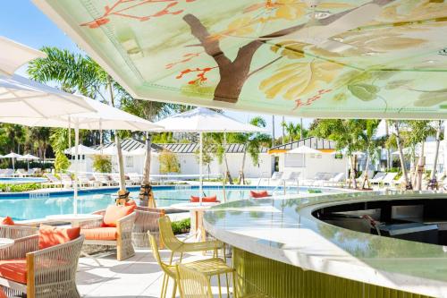 a poolside bar with tables and umbrellas at a resort at Tee Time Tranquility in Zephyrhills