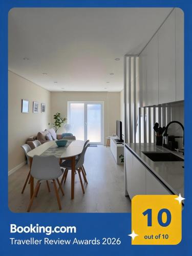 a kitchen and a dining room with a table and a kitchen at Barra Azul - Beach Apartment in Praia da Barra