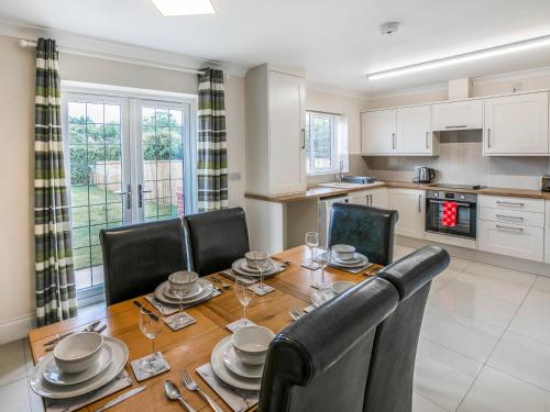 a kitchen and dining room with a table and chairs at Dawson Park 9 - Uk12668 in Mablethorpe