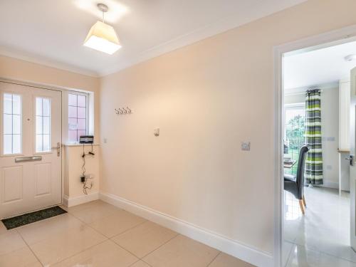 a hallway with a door to a room with a window at Dawson Park 9 - Uk12668 in Mablethorpe
