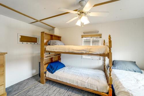 two bunk beds in a room with a ceiling fan at Walk to Loop Trail! East Wenatchee Basecamp in East Wenatchee