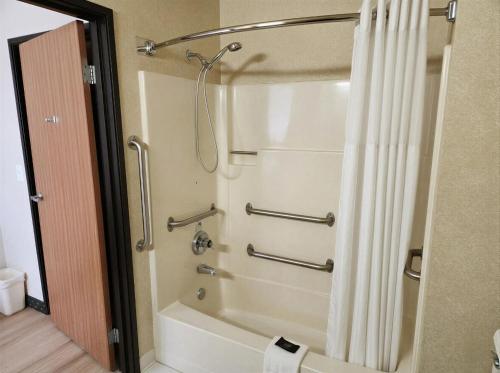 a bathroom with a shower with a shower curtain at Baymont by Wyndham Helena in Helena